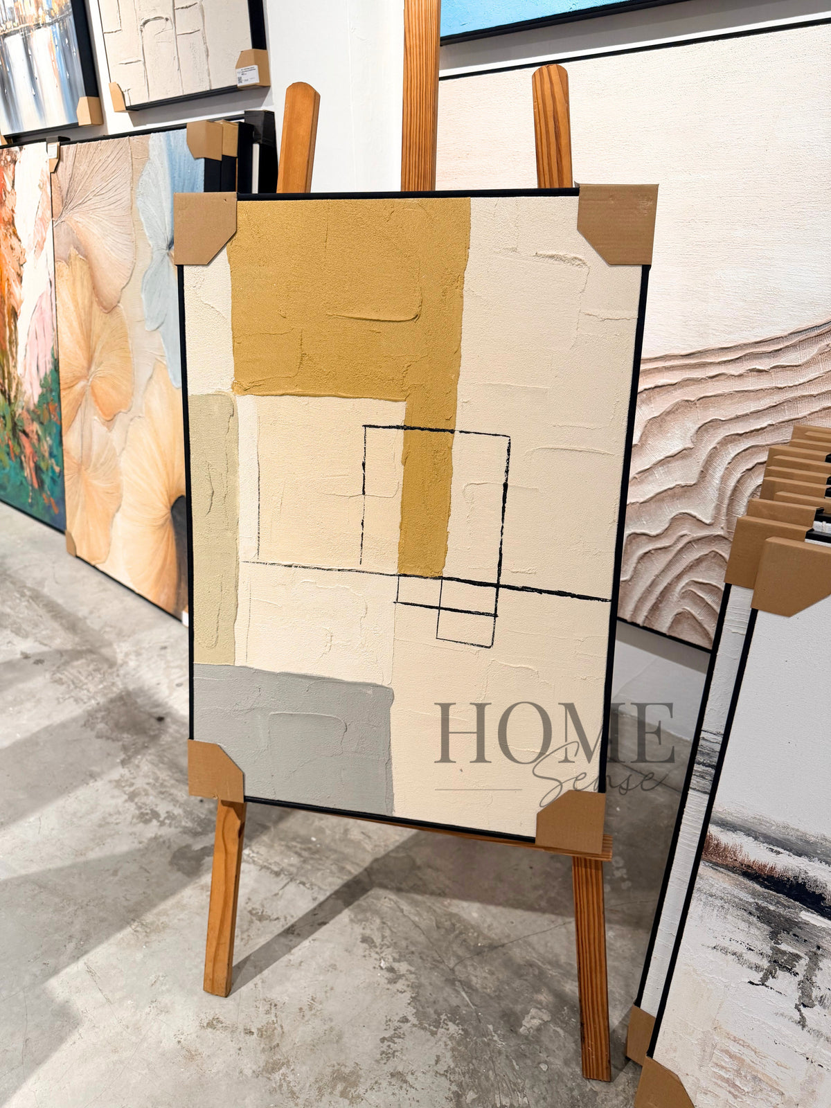 Angled view of Golden Alignment textured acrylic canvas with mustard gold, ivory and black geometric details