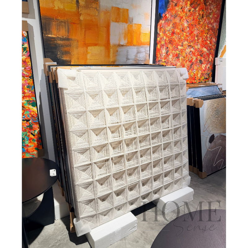 Modern ivory woven wall art featuring repeating geometric thread designs