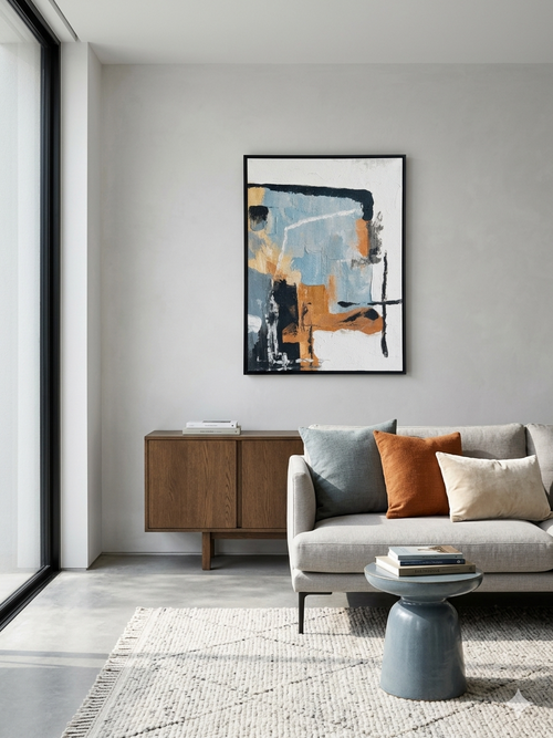 Modern living room with a gray sofa, wooden cabinet, and abstract art on the wall.
